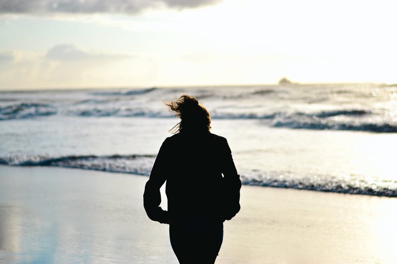 Woman Walking on Beach